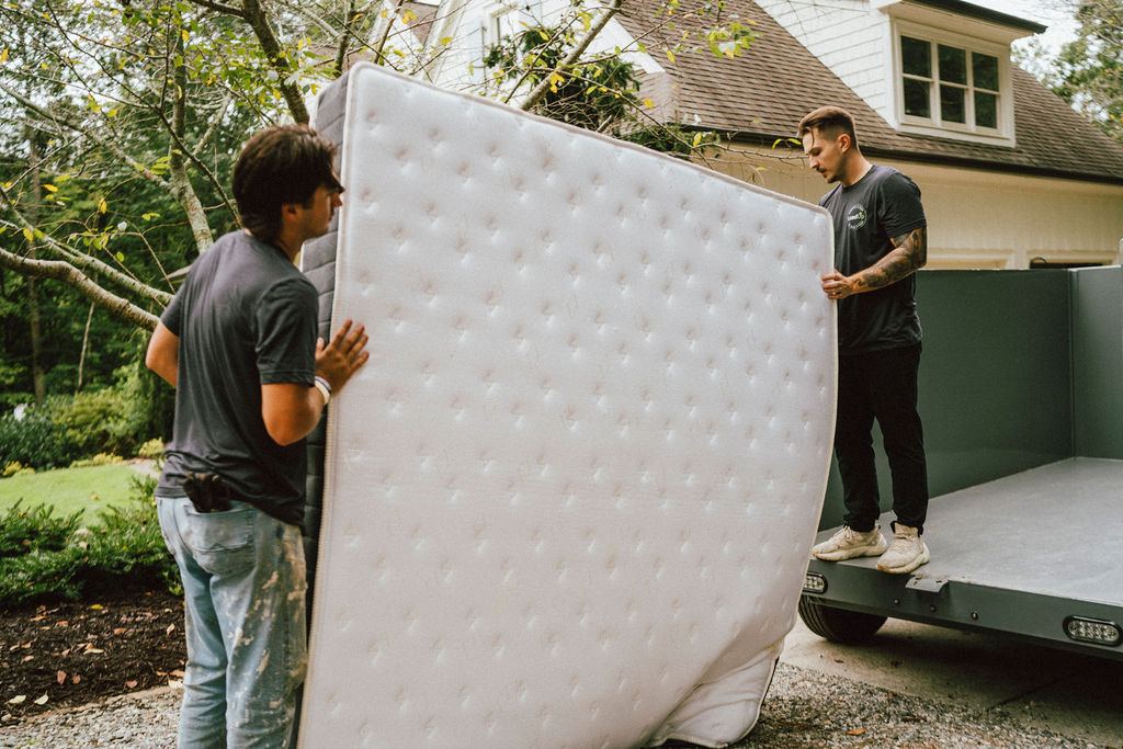Loaders hauling a box spring during a residential pickup like those we run in Decatur