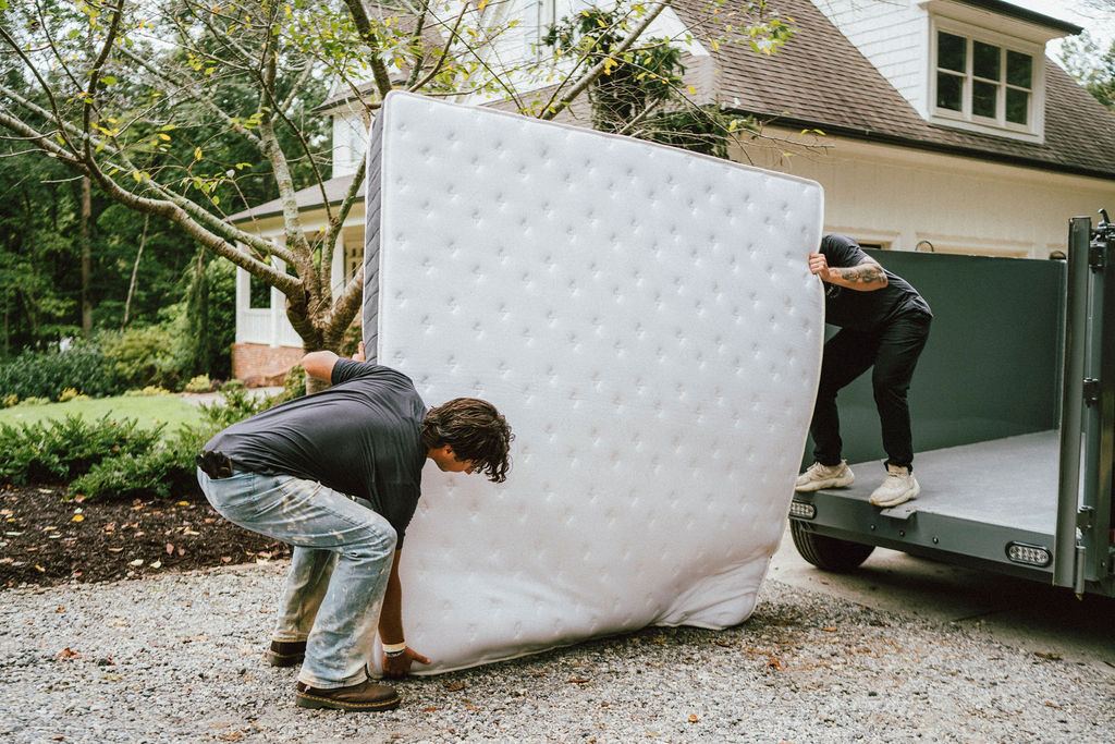 Loaders hauling a box spring during a residential pickup like those we run in Tucker