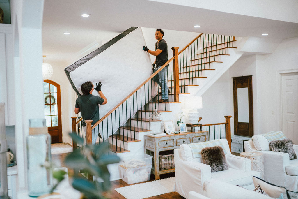 JRP Loaders carrying a mattress through a multifamily property during a tenant turn
